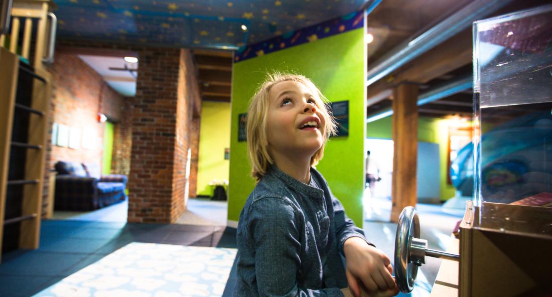 Young visitor looking up and enjoying the My Sky exhibit at the Boston Children's Museum